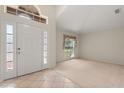 Welcoming foyer featuring tile flooring, natural light, and an arched transom window above the front door at 1330 Broken Pine Rd, Deltona, FL 32725