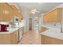 Well-lit kitchen with ample counter space, white appliances, and abundant storage at 1330 Broken Pine Rd, Deltona, FL 32725