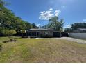 Charming single-story home with a well-maintained lawn and mature trees at 1433 Kingston Ave, Orlando, FL 32807