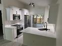 Bright kitchen featuring modern appliances, quartz countertops, and a cozy breakfast bar at 1538 Brookebridge Dr, Orlando, FL 32825