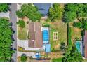 Aerial view of property featuring screened pool, fenced yard and mature trees at 1558 Regal Oak Dr, Kissimmee, FL 34744