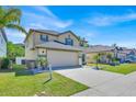 Well-maintained two-story home featuring a two-car garage, landscaped front yard, and inviting curb appeal at 16844 Rising Star Dr, Clermont, FL 34714