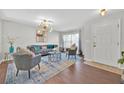 Cozy living room with modern lighting, hardwood floors, and comfortable seating arrangement at 16844 Rising Star Dr, Clermont, FL 34714