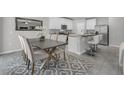 Elegant dining area adjacent to a modern kitchen, featuring a large table, and stylish seating at 17309 Cagan Crossing Blvd, Clermont, FL 34714