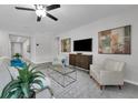 Comfortable living room features stylish furniture, a modern entertainment center, and inviting decor with a serene ambiance at 17309 Cagan Crossing Blvd, Clermont, FL 34714