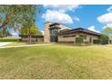 Stylish home exterior featuring manicured lawn and tasteful landscaping at 1766 Alaqua Dr, Longwood, FL 32779