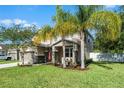 Beautiful home featuring well-manicured landscaping with palms and an attached two-car garage at 199 Boysenberry Ln, Daytona Beach, FL 32124