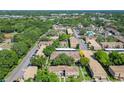 Aerial view of the multi-Gathering property showcasing mature trees, a swimming pool, and ample parking spaces at 200 Saint Andrews Blvd # 1004, Winter Park, FL 32792