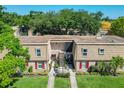 Charming two-story townhouse with red shutters, lush landscaping, and well-maintained lawn at 200 Saint Andrews Blvd # 1004, Winter Park, FL 32792
