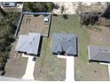 Aerial view of two modern homes with spacious yards and long driveways, showcasing a desirable neighborhood setting at 2082 Sw 153Rd Loop, Ocala, FL 34473