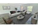 Bright living room featuring modern decor, stylish furnishings, ample seating, and wood-look flooring at 2082 Sw 153Rd Loop, Ocala, FL 34473