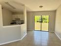 Cozy dining area with a sliding glass door and open access to the kitchen at 2431 Lackland Dr, Deltona, FL 32738