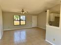 Bright living room with tiled floor, a ceiling fan, and a large window at 2431 Lackland Dr, Deltona, FL 32738