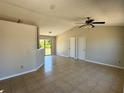Open-concept living room featuring tiled floor and neutral paint scheme at 2431 Lackland Dr, Deltona, FL 32738