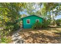 Charming single-story home features lush landscaping and a welcoming walkway at 290 Pine St, Ormond Beach, FL 32174