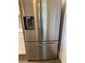 The stainless steel refrigerator adds a modern look to the kitchen at 459 Hamptoncrest Cir # 203, Lake Mary, FL 32746