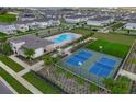 Beautiful aerial view showcases the community pool, recreational courts, and meticulously landscaped grounds at 4827 Lacewing Dr, Winter Garden, FL 34787