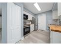 Bright kitchen showcasing stainless steel appliances, butcher block countertops, and a functional design with great storage at 5 Redwood Trace Run, Ocala, FL 34472