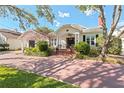 Charming home with brick drive, covered entry, beautiful landscaping, and a cozy, inviting appeal at 525 Sheridan Blvd, Orlando, FL 32804
