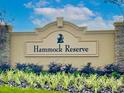 Entrance sign for Hammock Reserve with lush landscaping in the foreground at 5543 Maddie Dr, Haines City, FL 33844