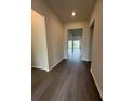 Inviting hallway boasts sleek wood-look flooring and neutral paint, leading to living spaces at 8243 Fenton St, Orlando, FL 32836