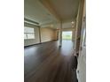 Open living room with dark wood floors, recessed lighting, and bright windows offers scenic views at 8243 Fenton St, Orlando, FL 32836
