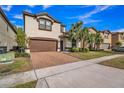 Charming two-story home with brick-paved driveway, attached two car garage, and a well-maintained lawn at 8840 Bengal Ct, Kissimmee, FL 34747