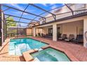 Spacious screened-in patio with a swimming pool and jacuzzi, complete with lounge chairs and outdoor dining set at 8840 Bengal Ct, Kissimmee, FL 34747