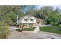 Charming two-story home with brick accents, a well-manicured lawn, and mature trees at 1204 Swan St, Winter Springs, FL 32708
