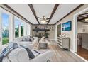 Inviting living space with exposed beams, a cozy fireplace, and stylish coastal decor, perfect for relaxation at 3168 S Peninsula Dr, Daytona Beach, FL 32118