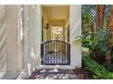 Inviting covered entryway with decorative gate and brick pavers for enhanced curb appeal at 8639 Lower Villagewalk Cir, Orlando, FL 32827