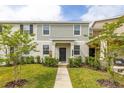 Charming two-story home featuring a well-maintained lawn, walkway, and neutral-tone exterior at 10684 Words Dr, Winter Garden, FL 34787