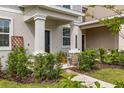 Inviting front porch with stone accents, decorative plants, and clear house number display at 10684 Words Dr, Winter Garden, FL 34787