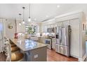 Bright kitchen featuring granite countertops, stainless steel appliances, and a breakfast bar at 1210 Baypoint Ct, Longwood, FL 32750