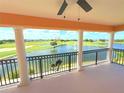 Expansive balcony showcasing picturesque views of the lush golf course and serene water features beyond at 1554 Corolla Ct, Reunion, FL 34747