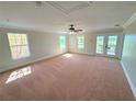 Bright, carpeted bedroom with natural light, neutral walls and private balcony at 1554 Corolla Ct, Reunion, FL 34747