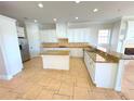 Well-equipped kitchen featuring granite countertops, stainless steel appliances, and ample cabinet space at 1554 Corolla Ct, Reunion, FL 34747