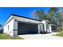 Single Gathering home with a white exterior, gray accents, well-manicured lawn, and a two car garage at 16358 Sw 27Th Terrace Rd, Ocala, FL 34473