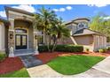 Stunning home featuring lush landscaping, manicured lawn, and an inviting front entry at 205 Torcaso Ct, Winter Springs, FL 32708
