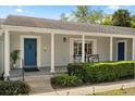 Inviting front porch with classic columns and a stylish blue front door at 2906 E Grant Ave, Orlando, FL 32806