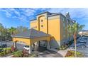 Inviting Galleria hotel entrance with a covered drop-off and colorful landscaping at 3000 Maingate Ln # 504, Kissimmee, FL 34747