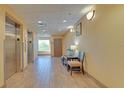 Well-lit Galleria hallway with elevators and table and chairs at 3000 Maingate Ln # 504, Kissimmee, FL 34747
