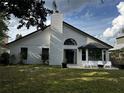 Backyard featuring a well maintained lawn, patio space and white siding at 3063 Ash Park Loop, Winter Park, FL 32792