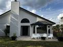 Backyard featuring a well maintained lawn, patio space and white siding at 3063 Ash Park Loop, Winter Park, FL 32792