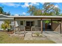 Inviting covered front porch with wooden railings and cozy seating area at 314 Avalone Dr, Apopka, FL 32703