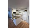 Bright kitchen with white cabinets, stone countertops, and modern appliances at 315 Lakepointe Dr # 201, Altamonte Springs, FL 32701