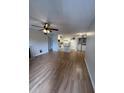 Spacious living room featuring hardwood floors, ceiling fan, and leading into kitchen at 315 Lakepointe Dr # 201, Altamonte Springs, FL 32701