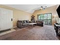 Cozy living room features a sliding door with access to a balcony at 325 Lakepointe Dr # 303, Altamonte Springs, FL 32701