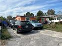 Residential area with multiple parked cars in front of an orange single-story home at 330 S Buena Vista Ave, Orlando, FL 32835