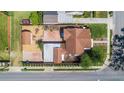 Aerial view of fenced in backyard with patio, driveway and well maintained landscaping at 335 W Bay St, Winter Garden, FL 34787
